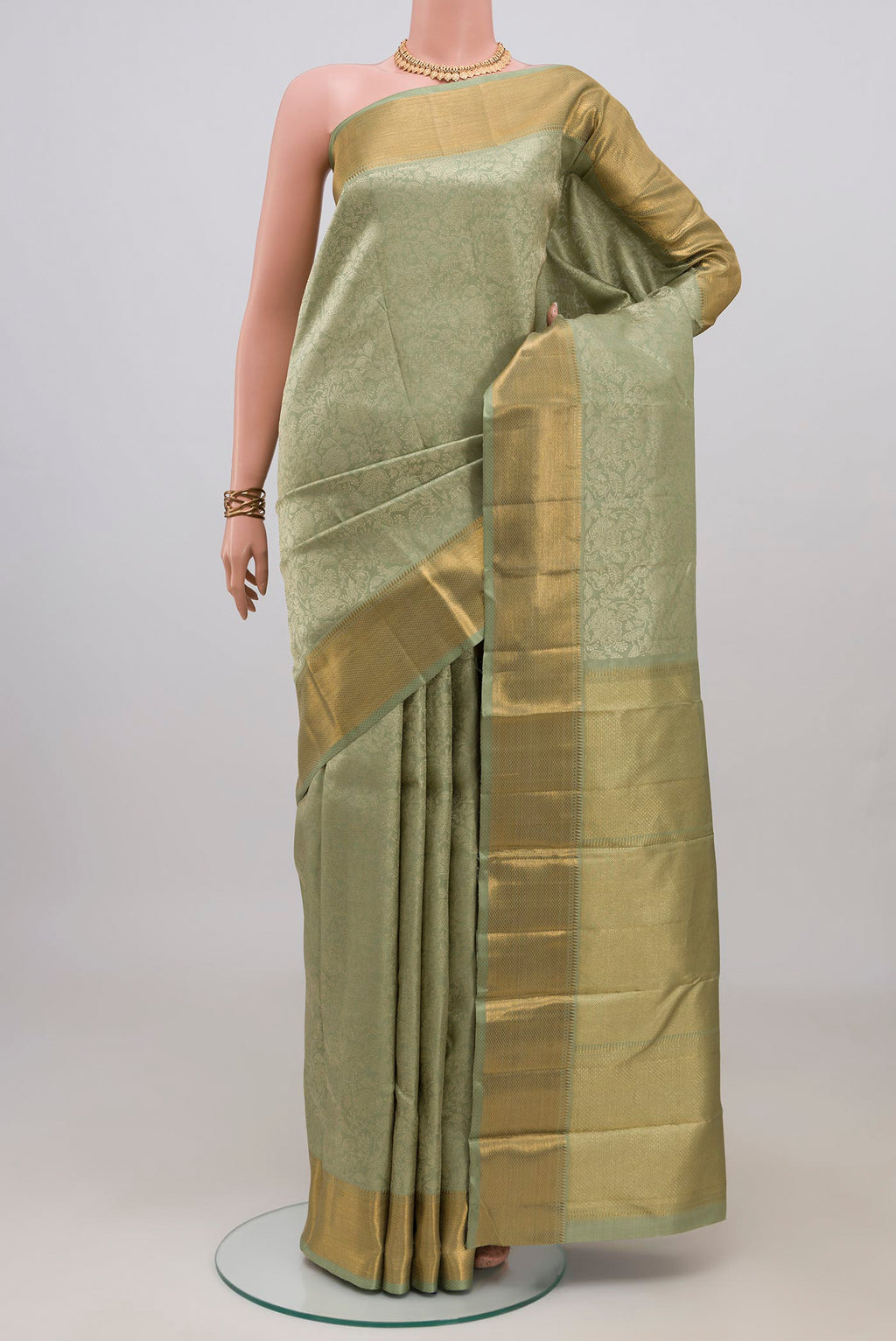 Sage Green Kanchipuram Silk Saree with Zari Brocade on the body and Zari Border.  displayed on a mannequin
