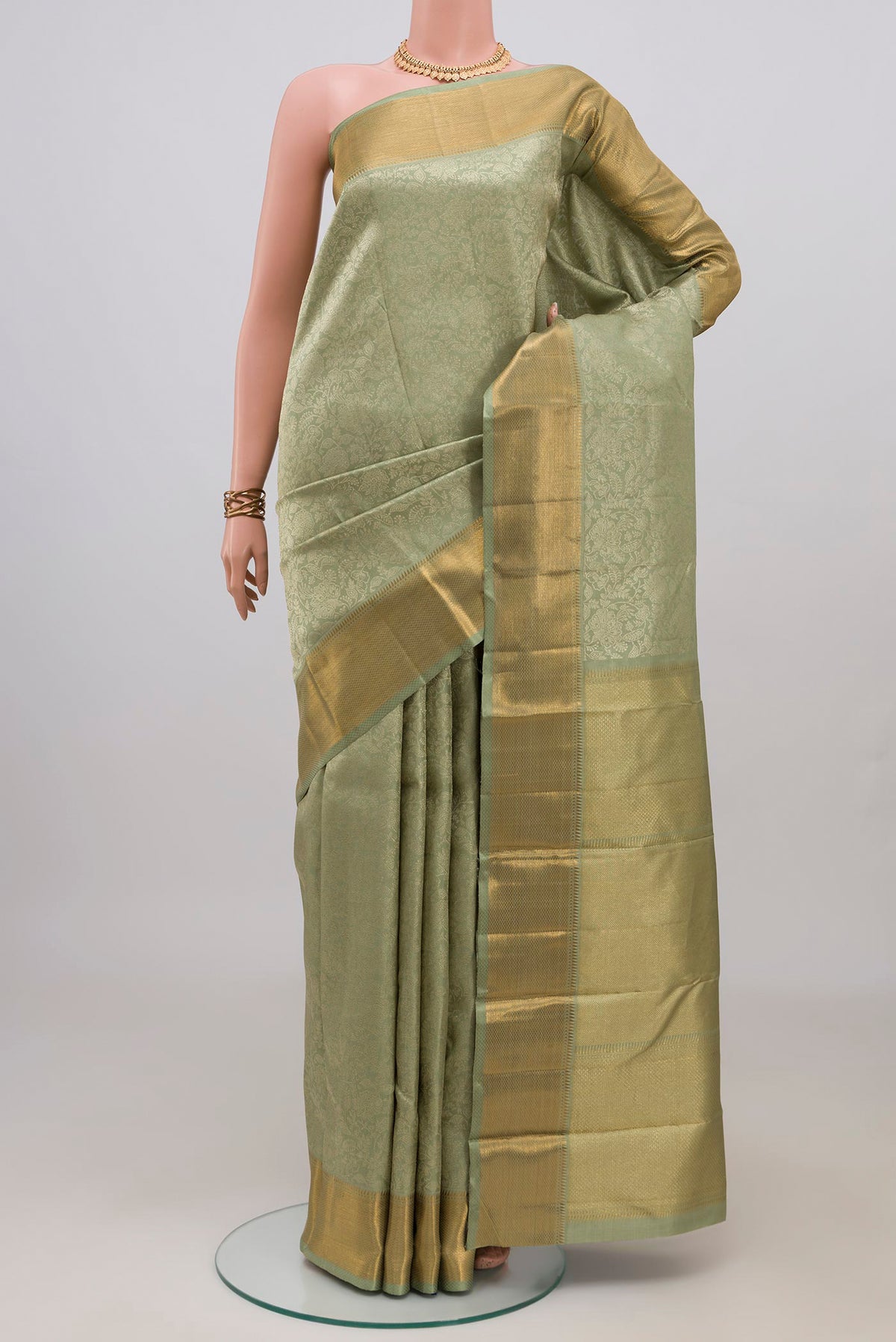 Sage Green Kanchipuram Silk Saree with Zari Brocade on the body and Zari Border.  displayed on a mannequin