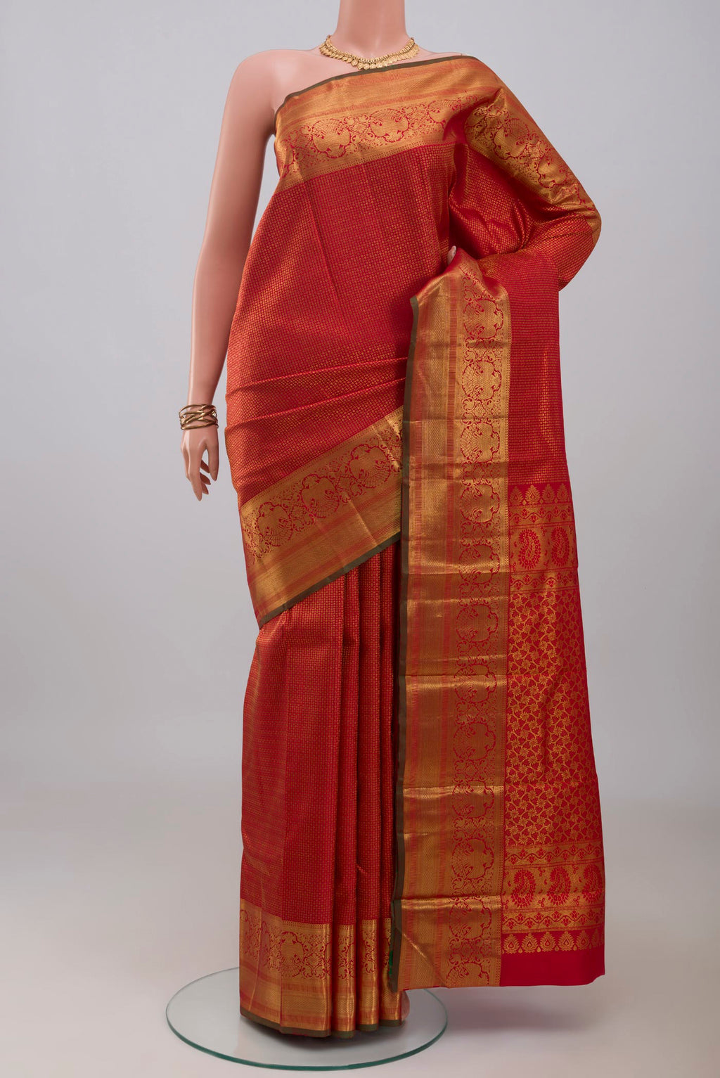 Red Kanchipuram Silk Saree with Zari Brocade on the body and Zari Border.  displayed on a mannequin