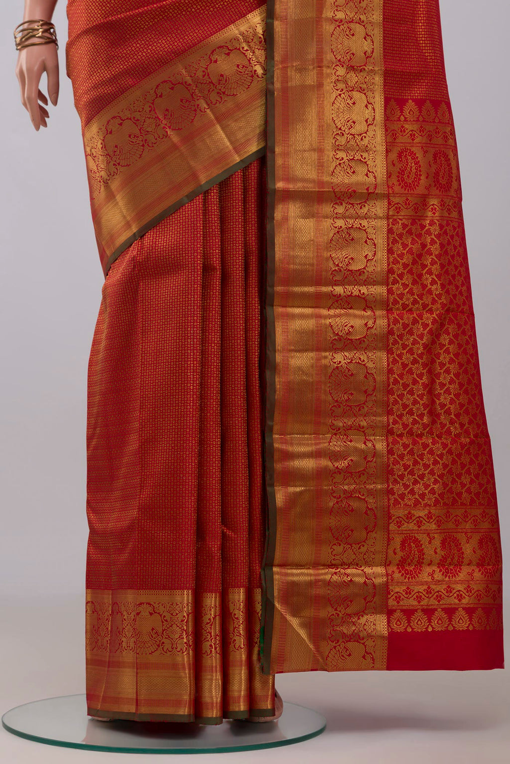 Pleats and pallu of Red Kanchipuram Silk Saree with Zari Brocade on the body and Zari Border. 
