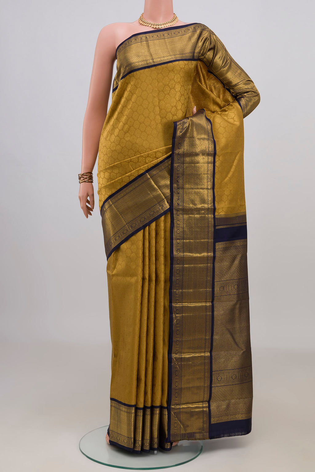 Pure Silk Golden Kanjivaram Saree with Zari Brocade on the body and Zari Border.  displayed on a mannequin