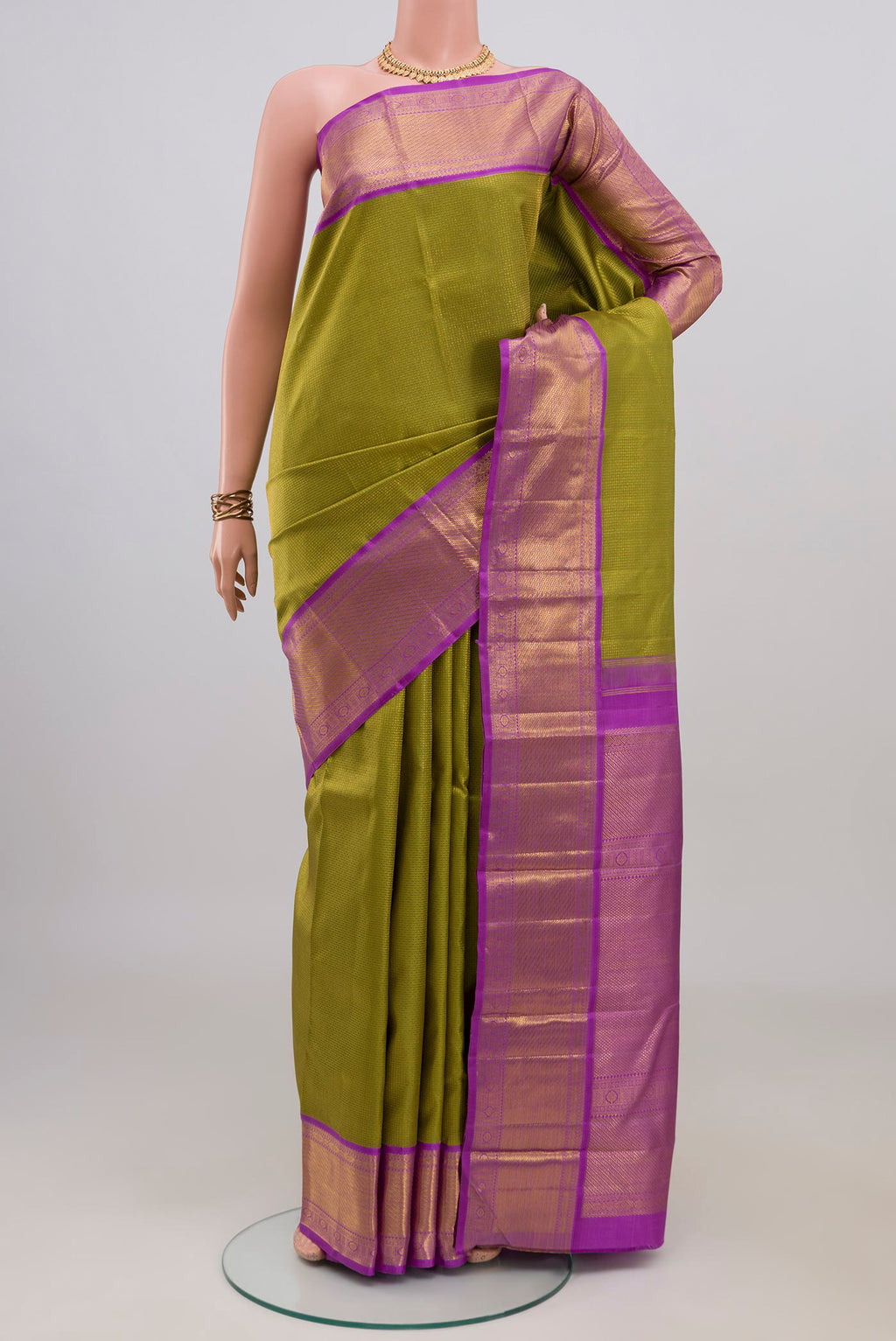 Green Kanjivaram Silk Saree with Zari Brocade on the body and Zari Border.  displayed on a mannequin