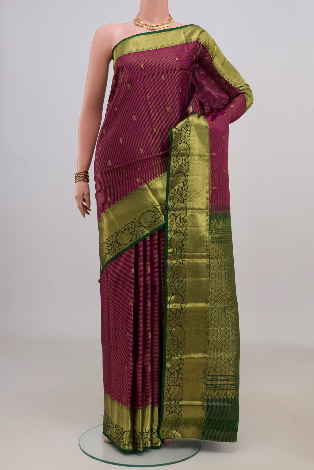 Pure Silk Magenta Kanchipuram Saree with Zari Butta on the body and Zari Border.  displayed on a mannequin