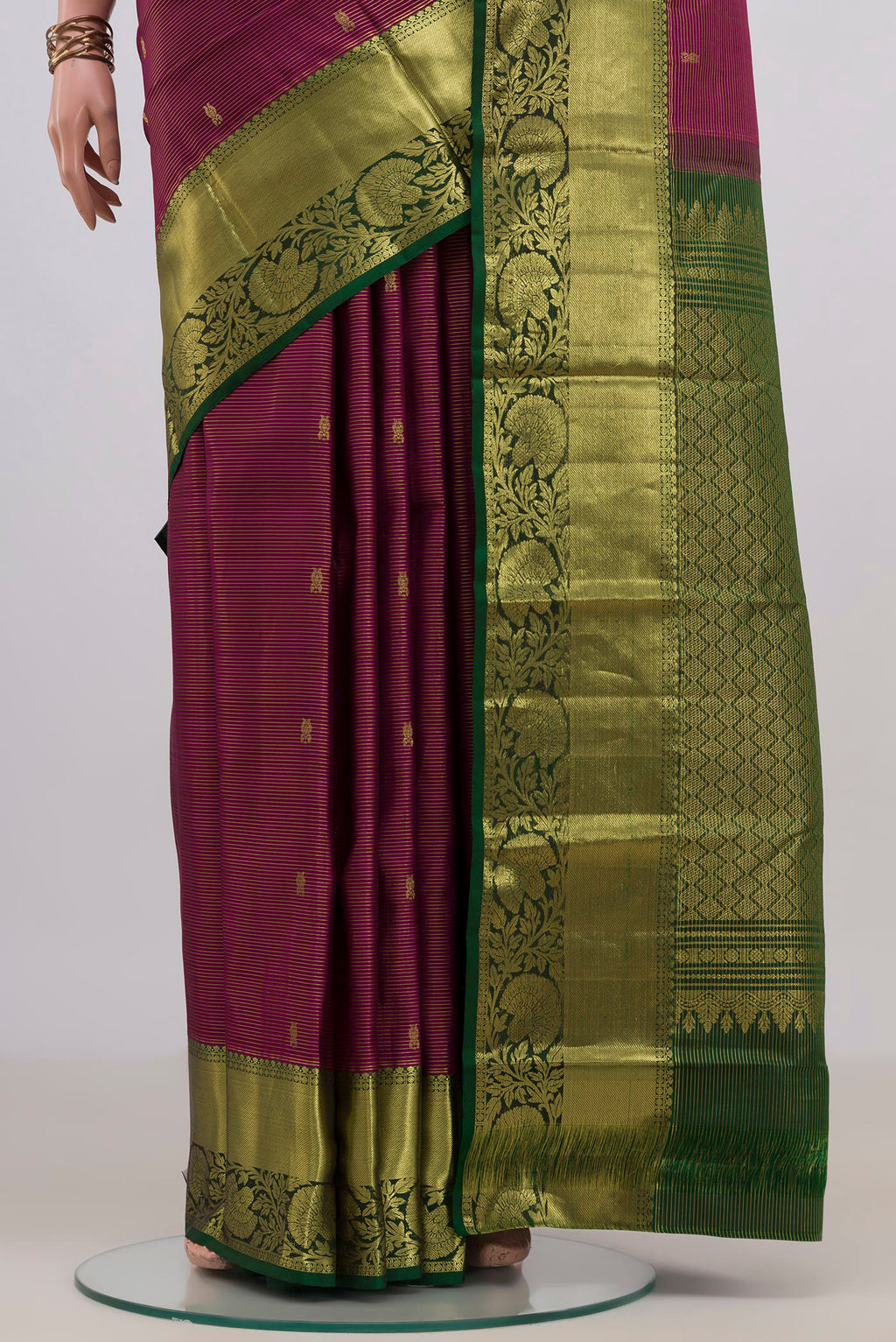 Pleats and pallu of Pure Silk Magenta Kanchipuram Saree with Zari Butta on the body and Zari Border. 