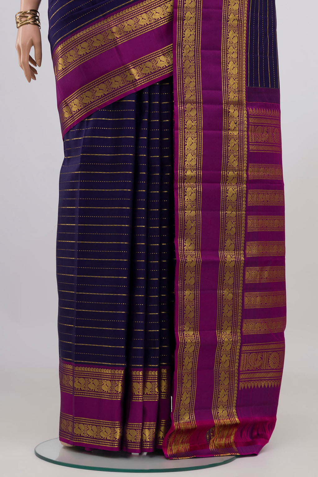 Pleats and pallu of Navy Blue Kanchipuram Silk Saree with Stripes on the body and Zari Border. 