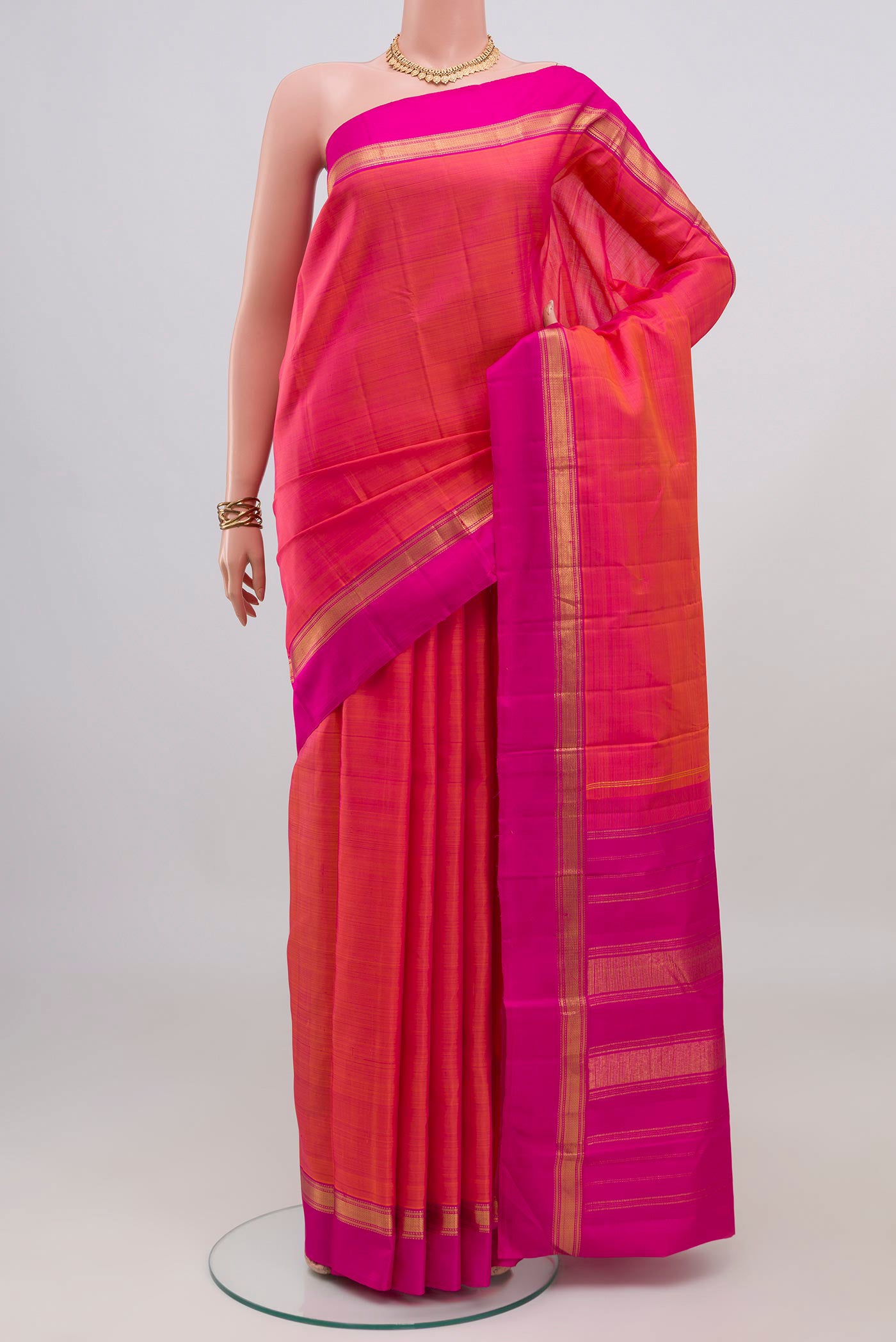 Pink with Orange Color Kanjivaram Silk Saree with Plain Body and Zari Border.  displayed on a mannequin
