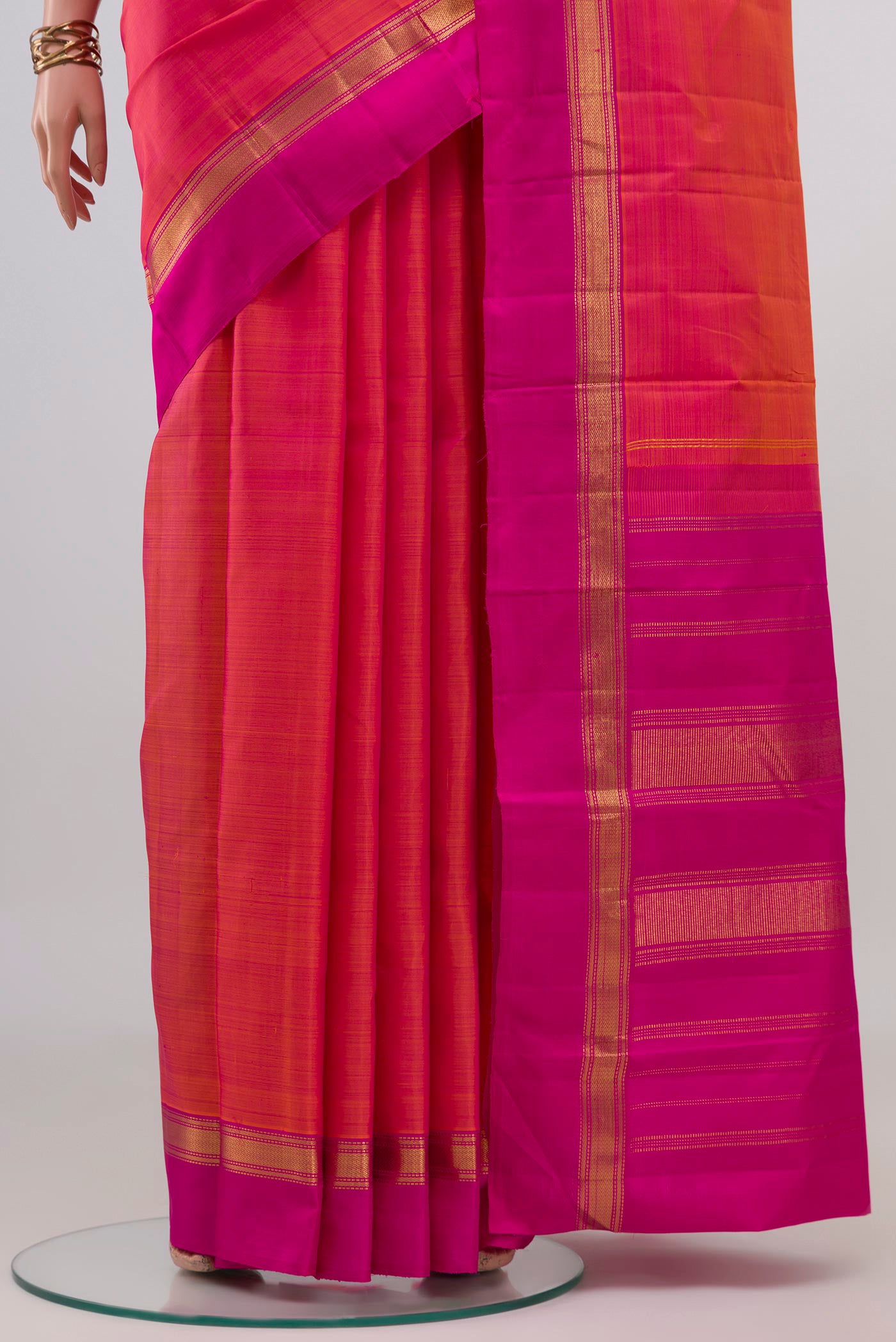 Pleats and pallu of Pink with Orange Color Kanjivaram Silk Saree with Plain Body and Zari Border. 
