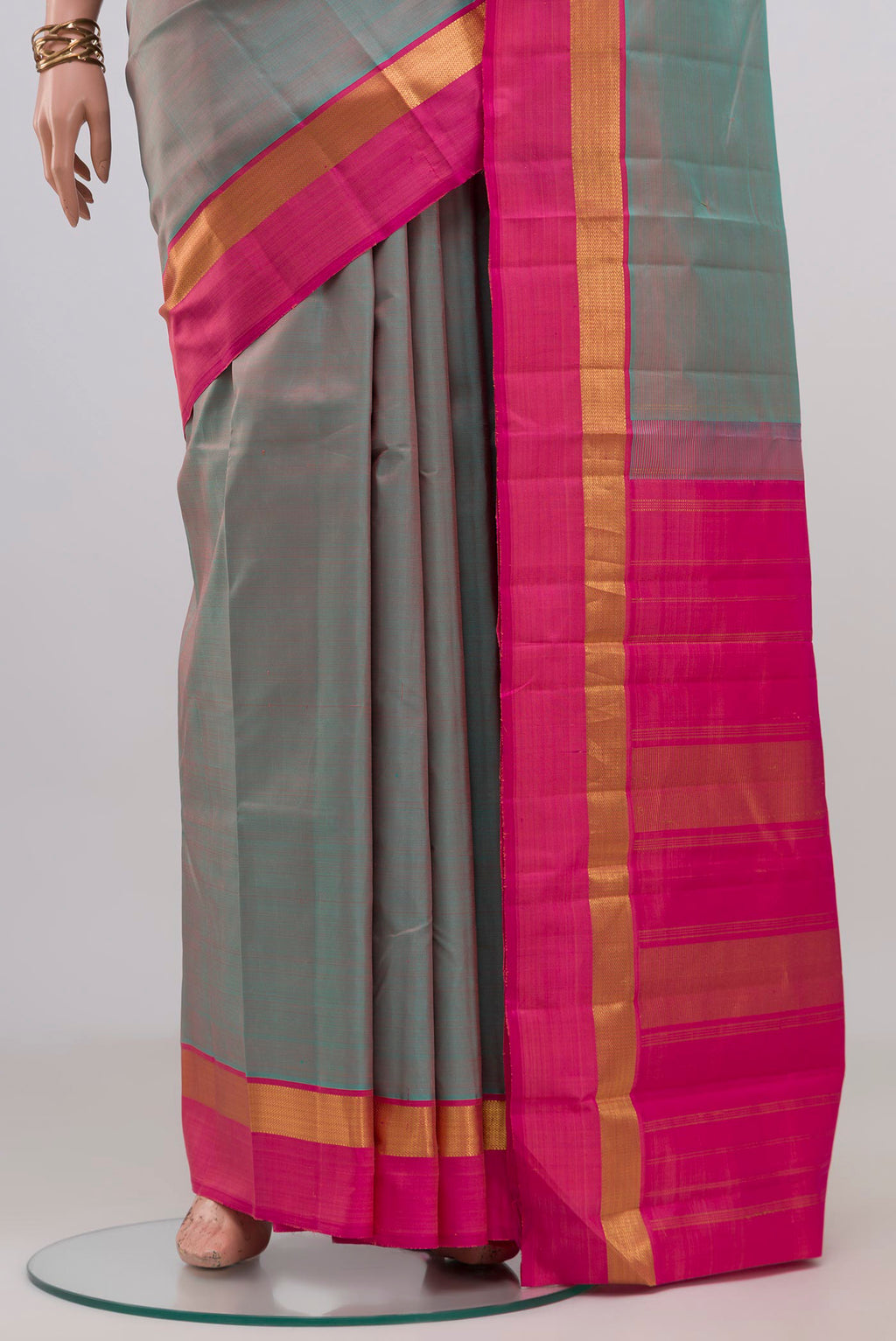Pleats and pallu of Grey with Pink Color Kanjivaram Silk Saree with Plain Body and Zari Border. 