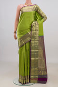 Pure Silk Parrot Green Kanchipuram Saree with Zari Brocade on the body and Zari Border.  displayed on a mannequin