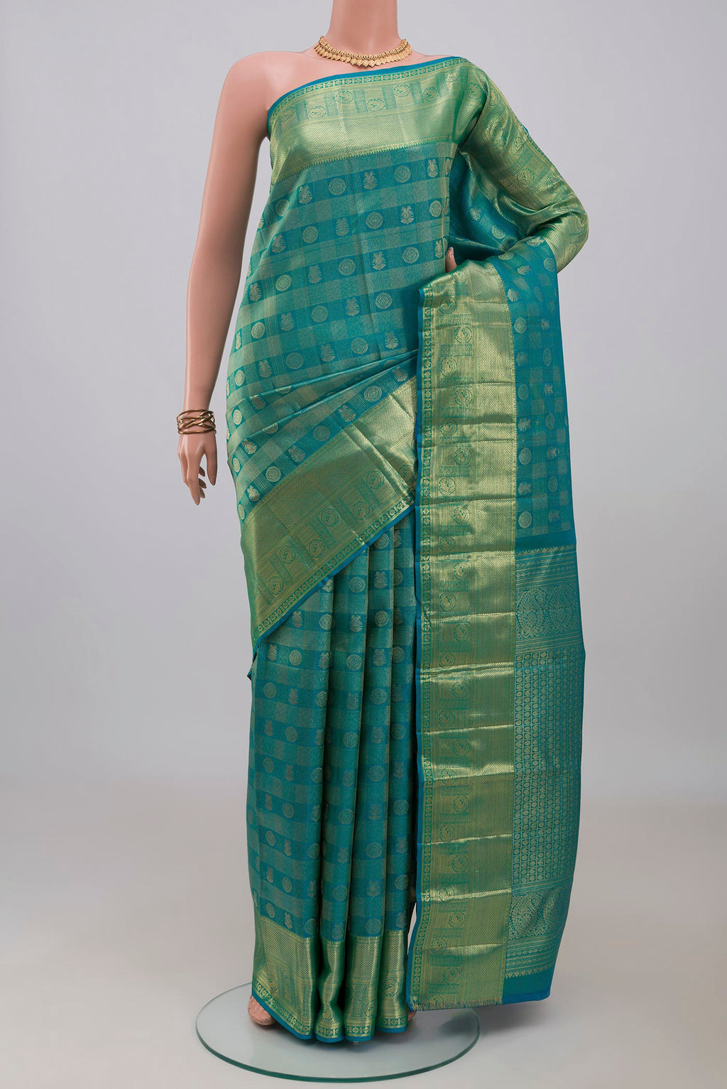 Blue Kanchipuram Silk Saree with Zari Brocade on the body and Zari Border.  displayed on a mannequin