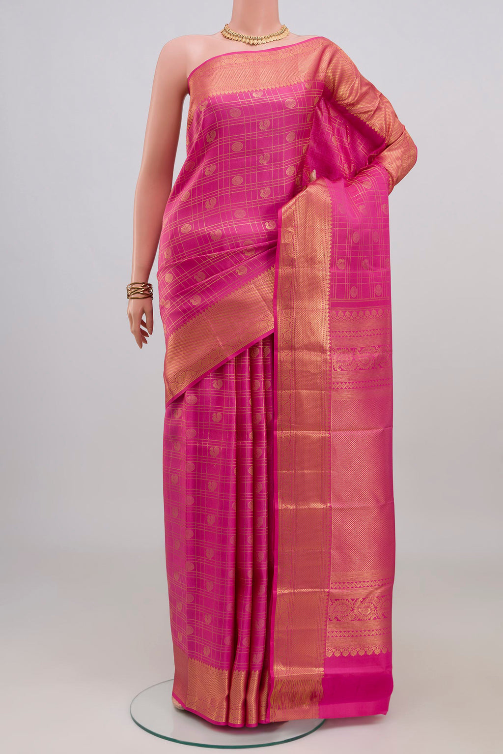 Pink Kanchipuram Silk Saree with Checked design on the body and Zari Border.  displayed on a mannequin