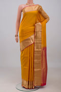 Yellow Soft Silk Saree with Zari Butta on the body and Zari Border.  displayed on a mannequin