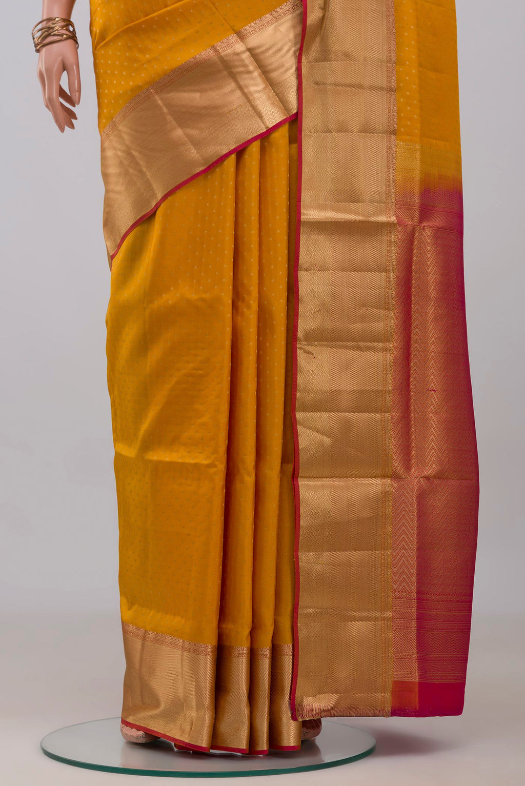 Pleats and pallu of Yellow Soft Silk Saree with Zari Butta on the body and Zari Border. 