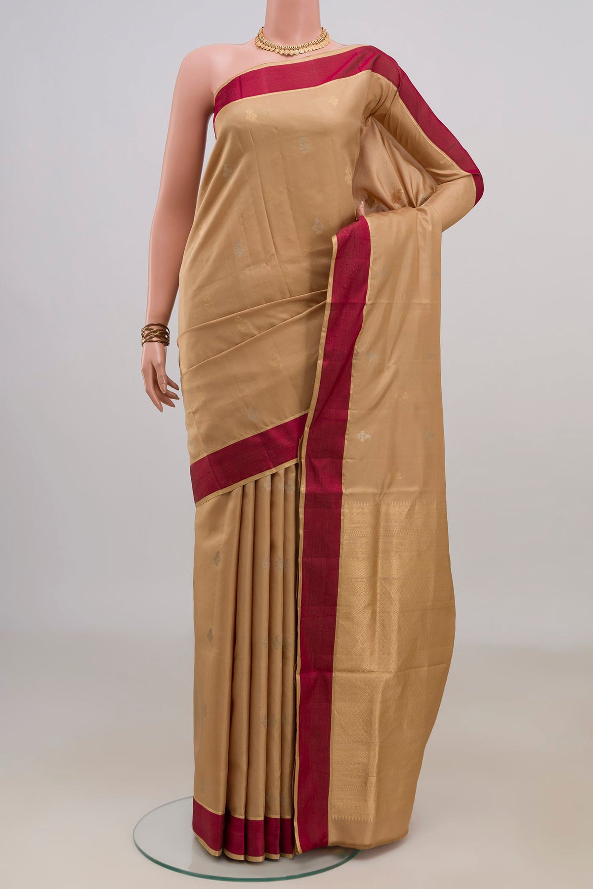 Pure Silk Sandal Soft Saree with Zari Butta on the body and Thin Zari Line.  displayed on a mannequin