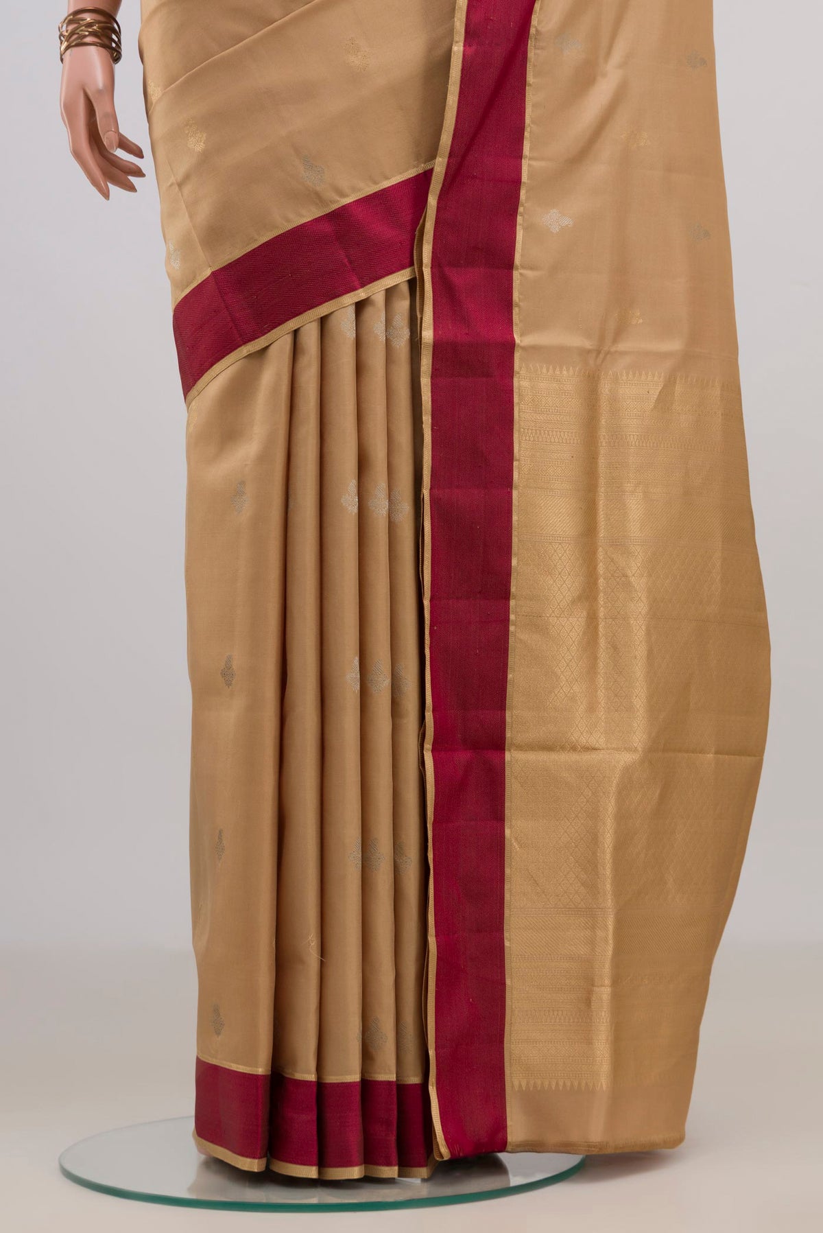 Pleats and pallu of Pure Silk Sandal Soft Saree with Zari Butta on the body and Thin Zari Line. 