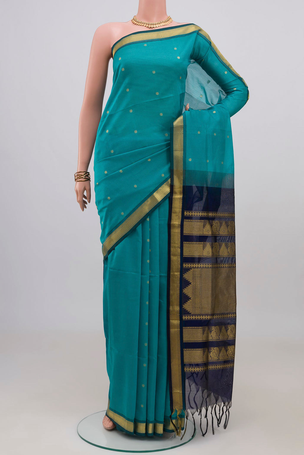 Light Blue Silk Cotton Saree with Zari Butta on the body and Zari Border.  displayed on a mannequin