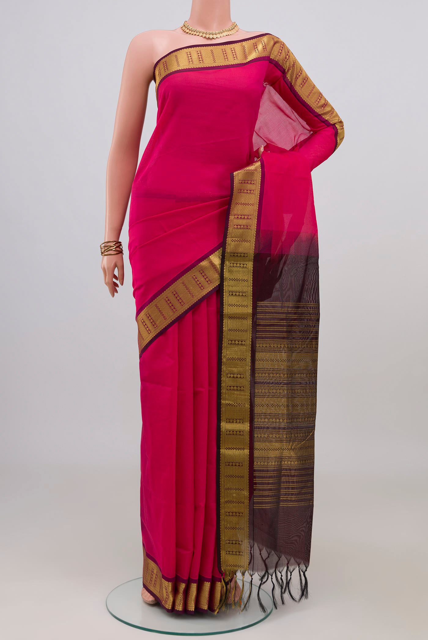 Pink Silk Cotton Saree with Plain Body and Zari Border.  displayed on a mannequin