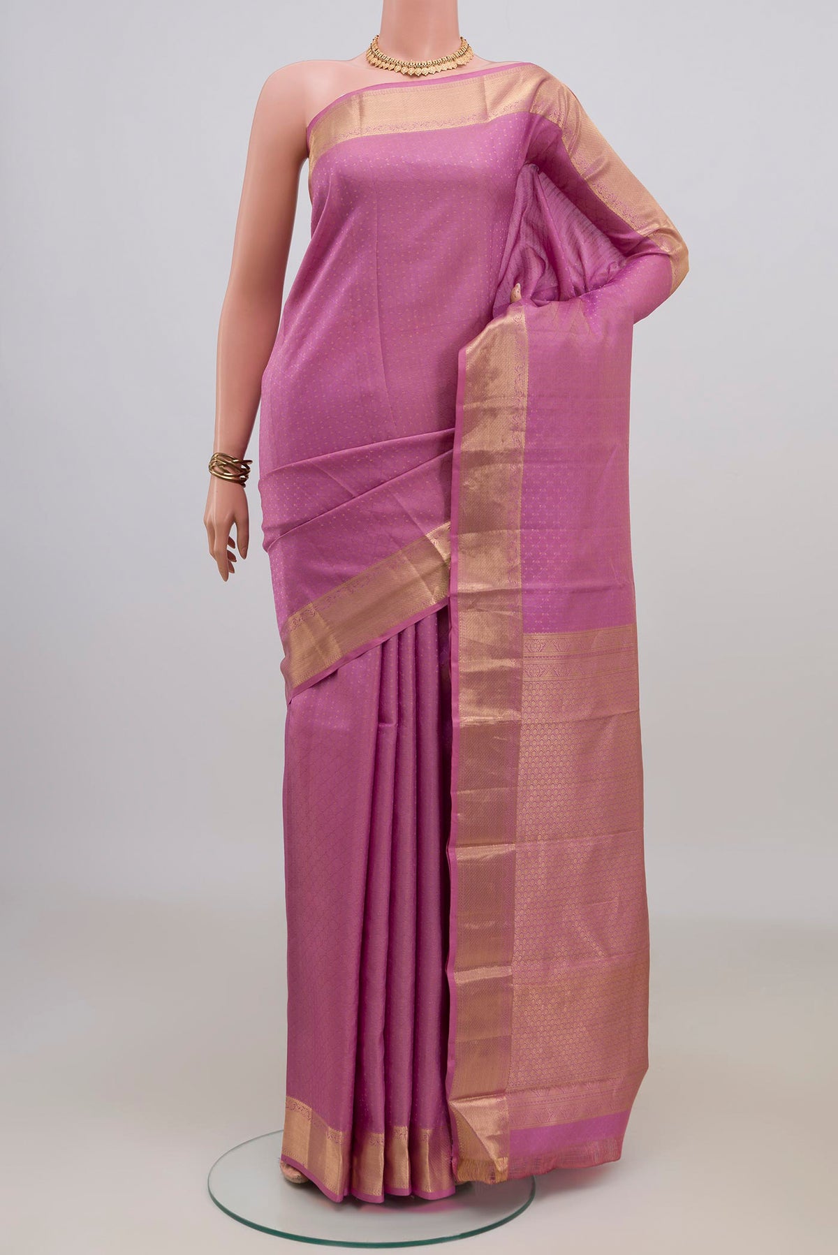Pure Silk Pink Kanjivaram Saree with Jacquard design on the body and Zari Border.  displayed on a mannequin