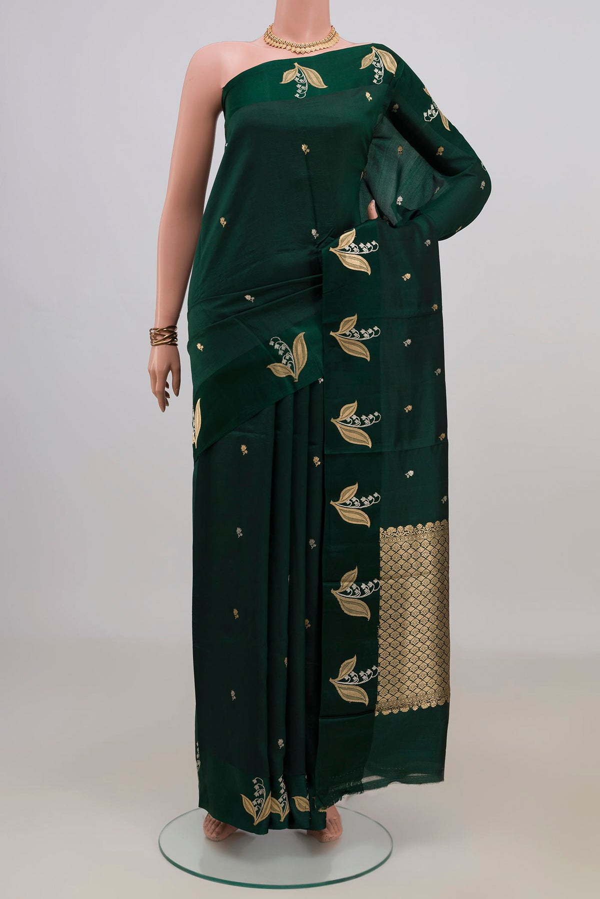 Pure Silk Bottle Green Banarasi Katan Saree with Zari Butta on the body and Fancy Border.  displayed on a mannequin