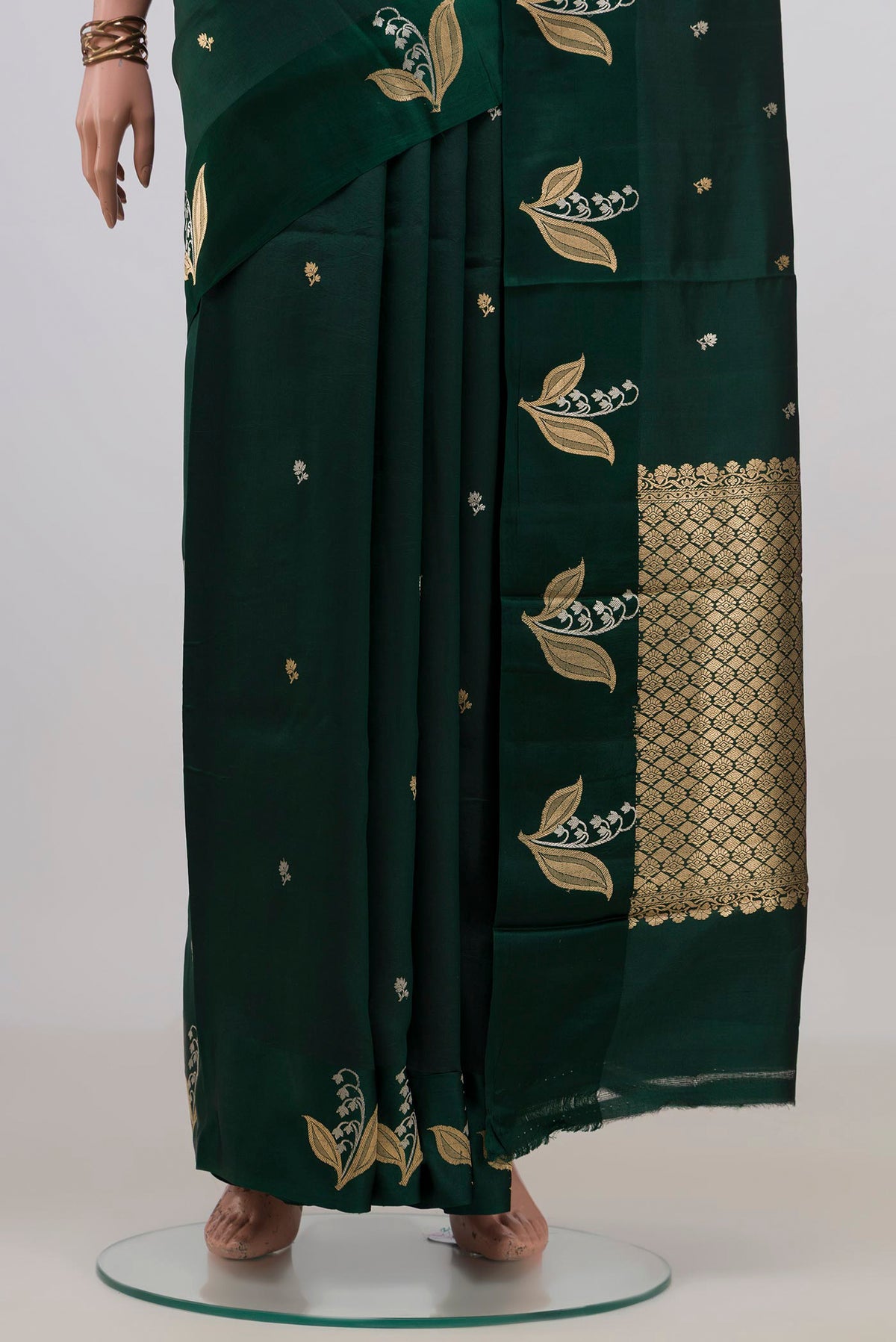 Pleats and pallu of Pure Silk Bottle Green Banarasi Katan Saree with Zari Butta on the body and Fancy Border. 