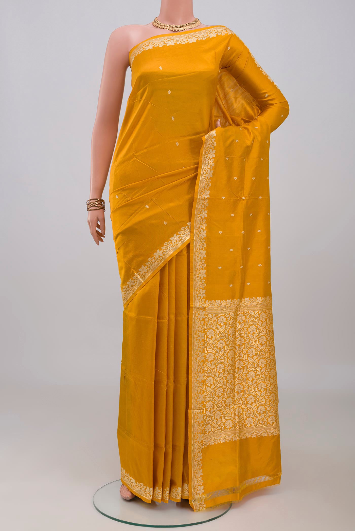 Yellow Banarasi Katan Silk Saree with Thread Butta on the body and Thread Border.  displayed on a mannequin