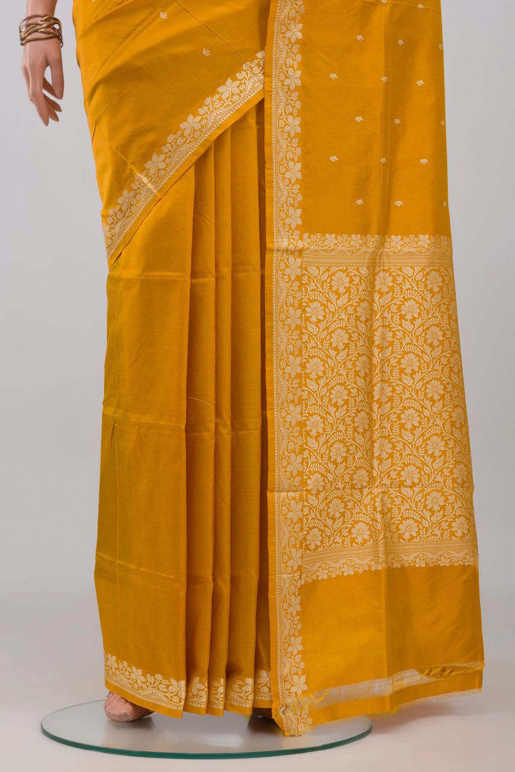 Pleats and pallu of Yellow Banarasi Katan Silk Saree with Thread Butta on the body and Thread Border. 