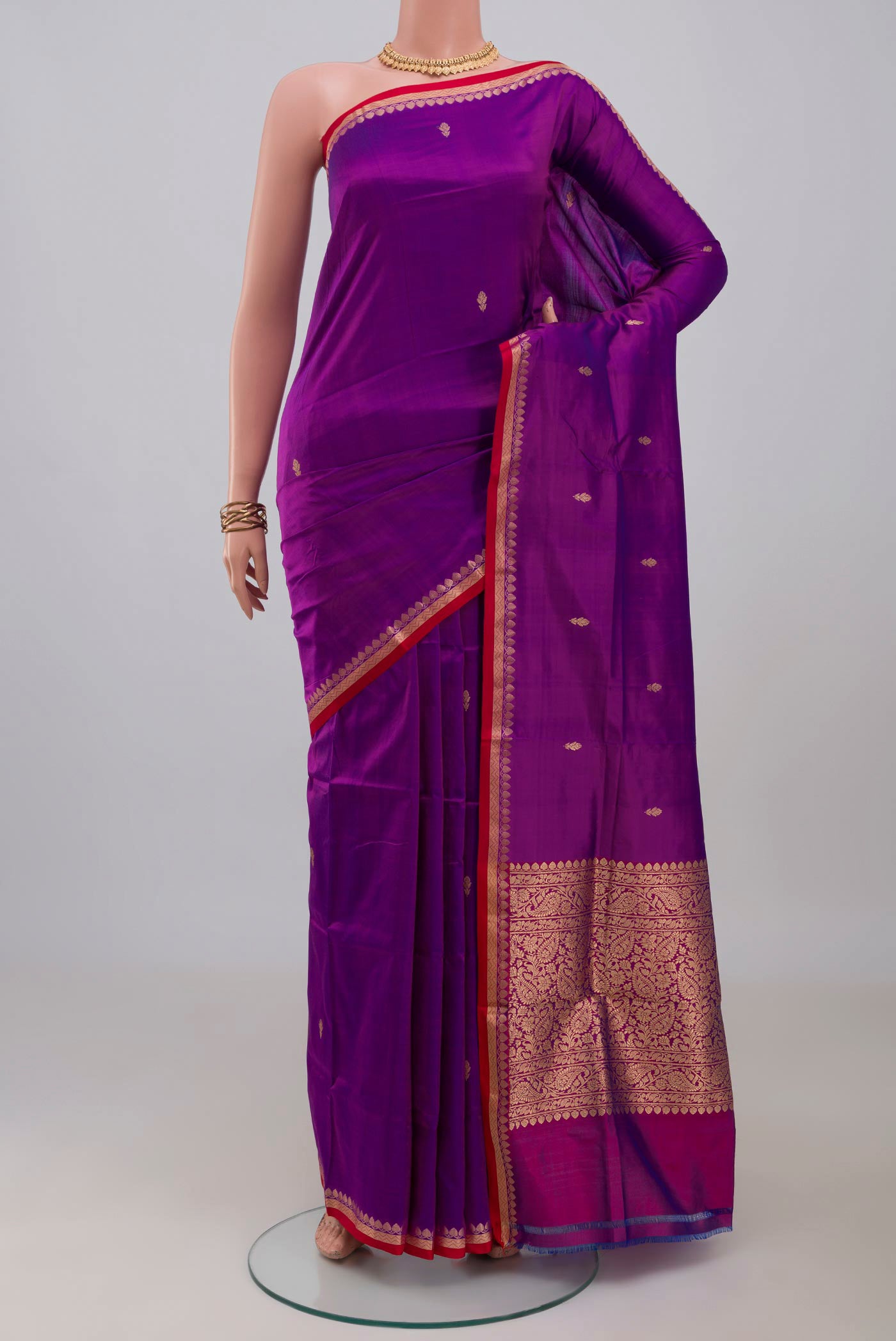 Purple Banarasi Katan Silk Saree with Zari Butta on the body and Thin Zari Line.  displayed on a mannequin