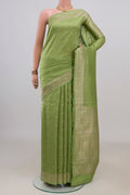Pure Silk Pista Green Tussar Saree with Stripes on the body and Zari Border.  displayed on a mannequin
