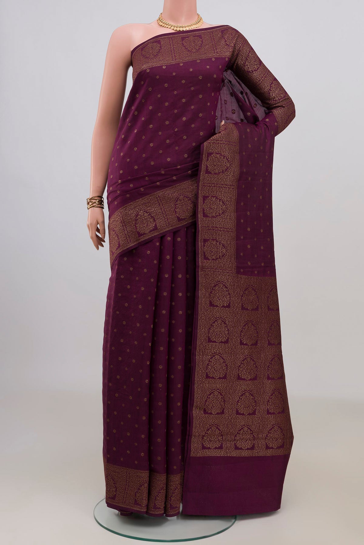 Pure Silk Burgundy Tussar Saree with Zari Butta on the body and Zari Border.  displayed on a mannequin
