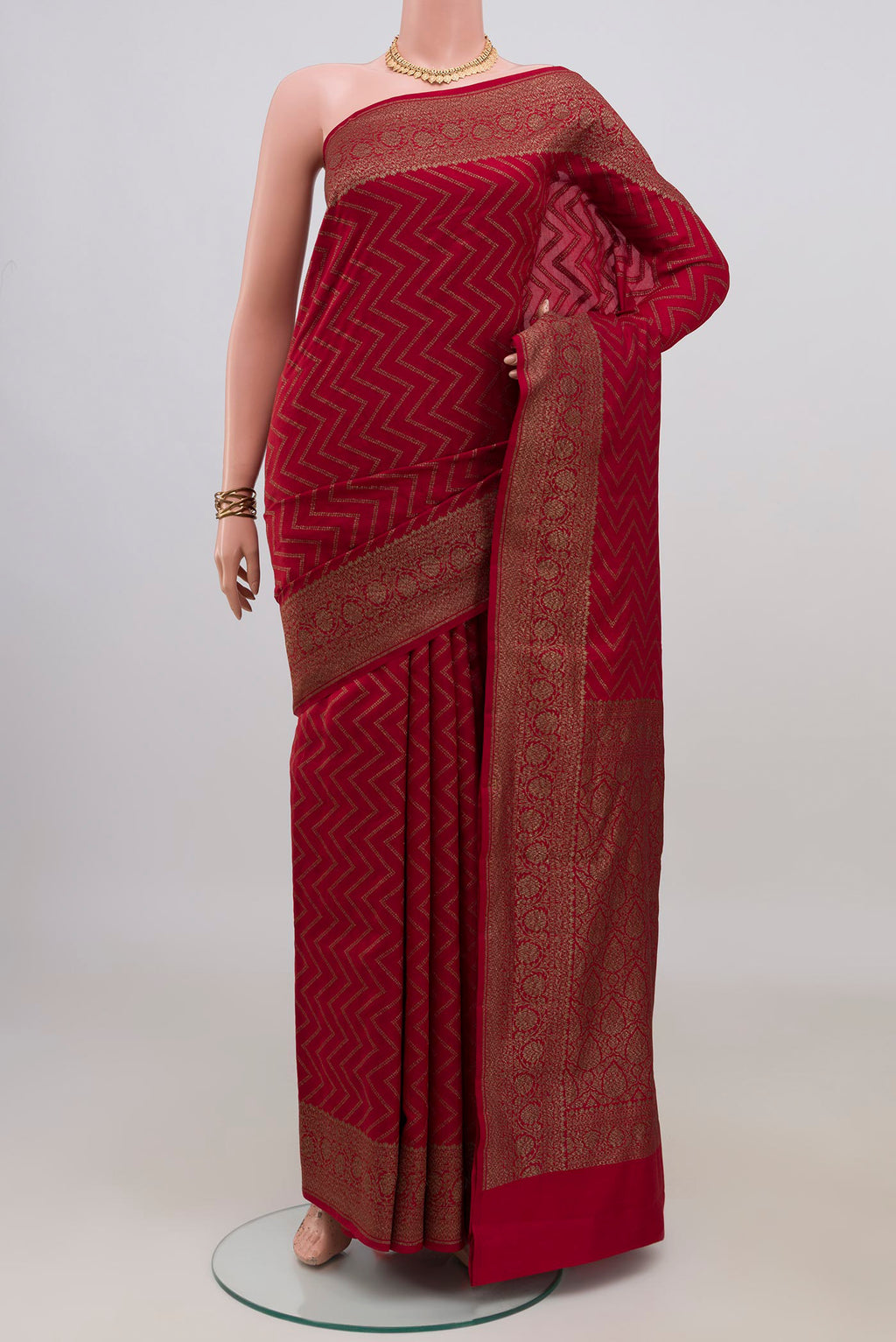 Pure Silk Maroon Banarasi Raw Saree with Zig Zag design on the body and Zari Border.  displayed on a mannequin