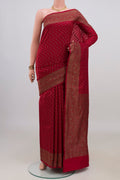 Pure Silk Maroon Banarasi Raw Saree with Zig Zag design on the body and Zari Border.  displayed on a mannequin