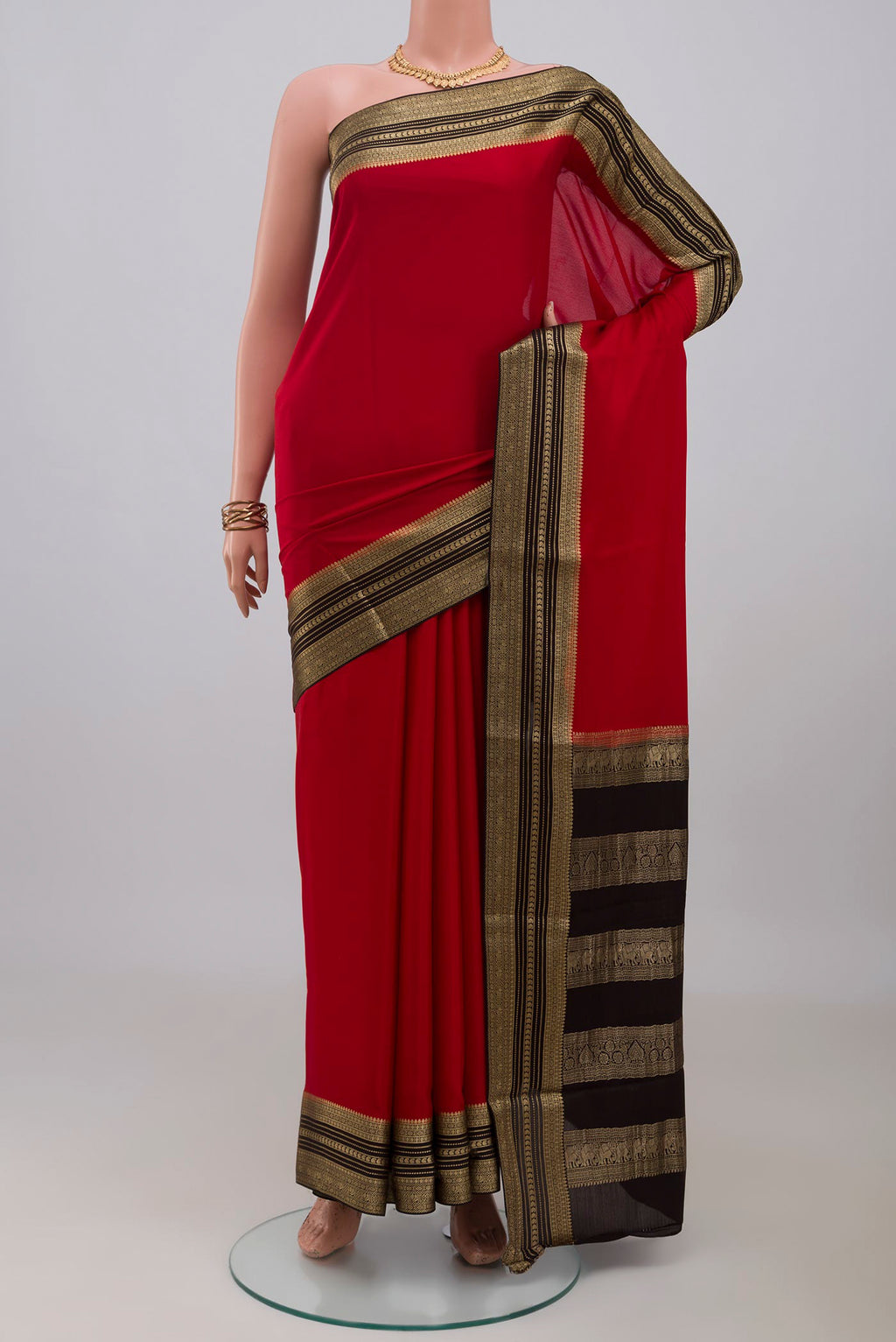 Red Mysore Crepe Saree with Plain Body and Zari Border.  displayed on a mannequin