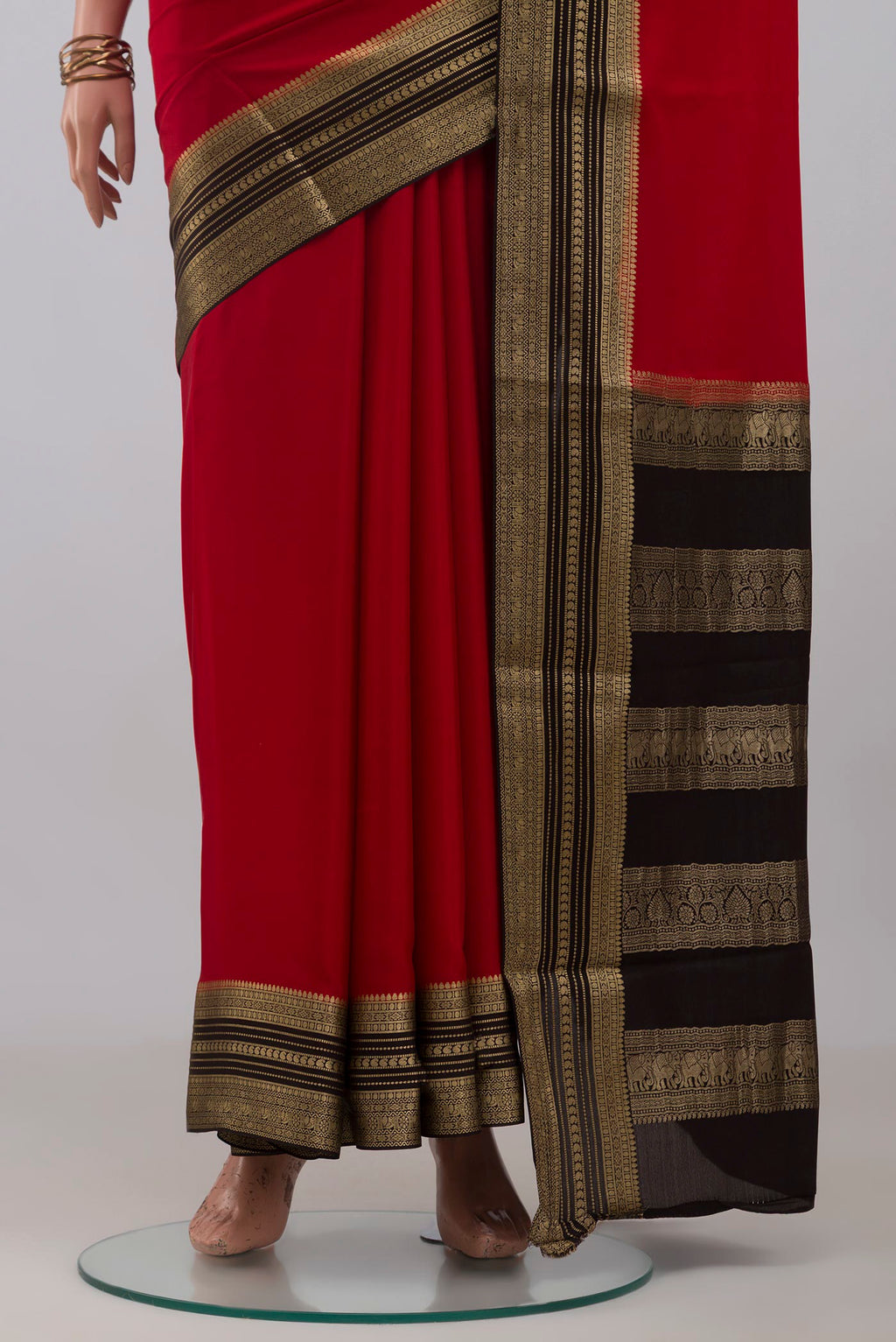 Pleats and pallu of Red Mysore Crepe Saree with Plain Body and Zari Border. 