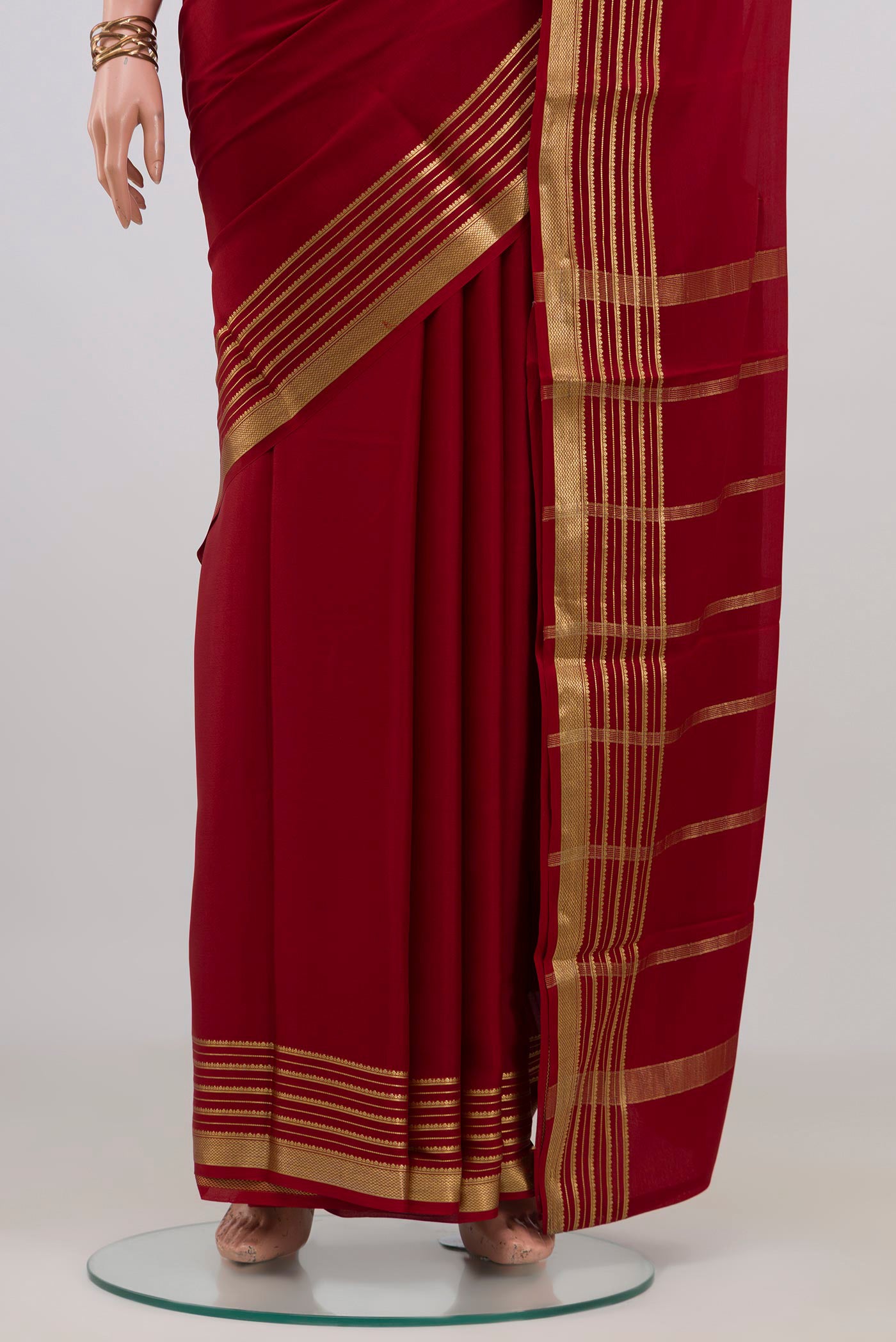 Pleats and pallu of Maroon Mysore Crepe Saree with Plain Body and Zari Border. 