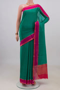Green Mysore Crepe Saree with Plain Body and Plain Border.  displayed on a mannequin
