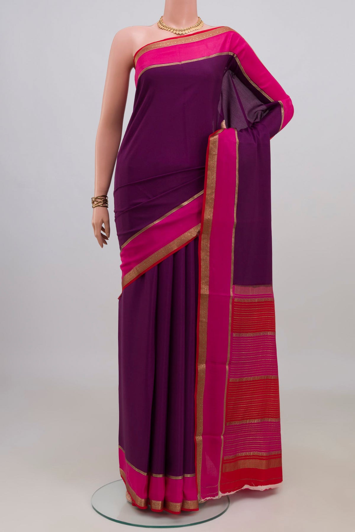 Magenta Mysore Crepe Saree with Plain Body and Zari Border.  displayed on a mannequin