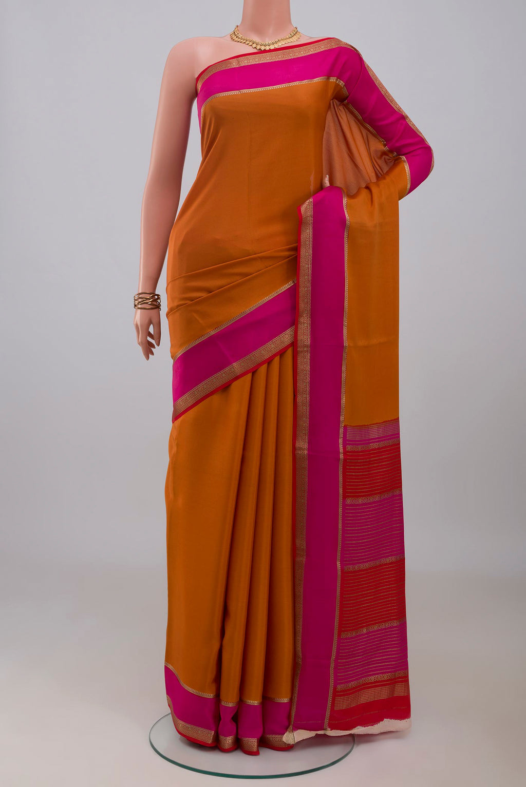 Mustard Mysore Crepe Saree with Plain Body and Zari Border.  displayed on a mannequin