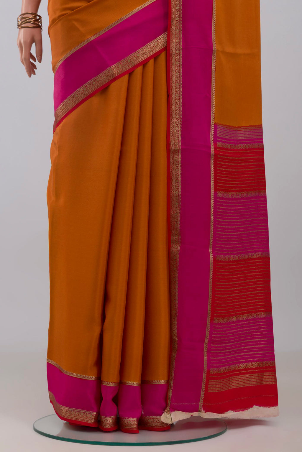 Pleats and pallu of Mustard Mysore Crepe Saree with Plain Body and Zari Border. 