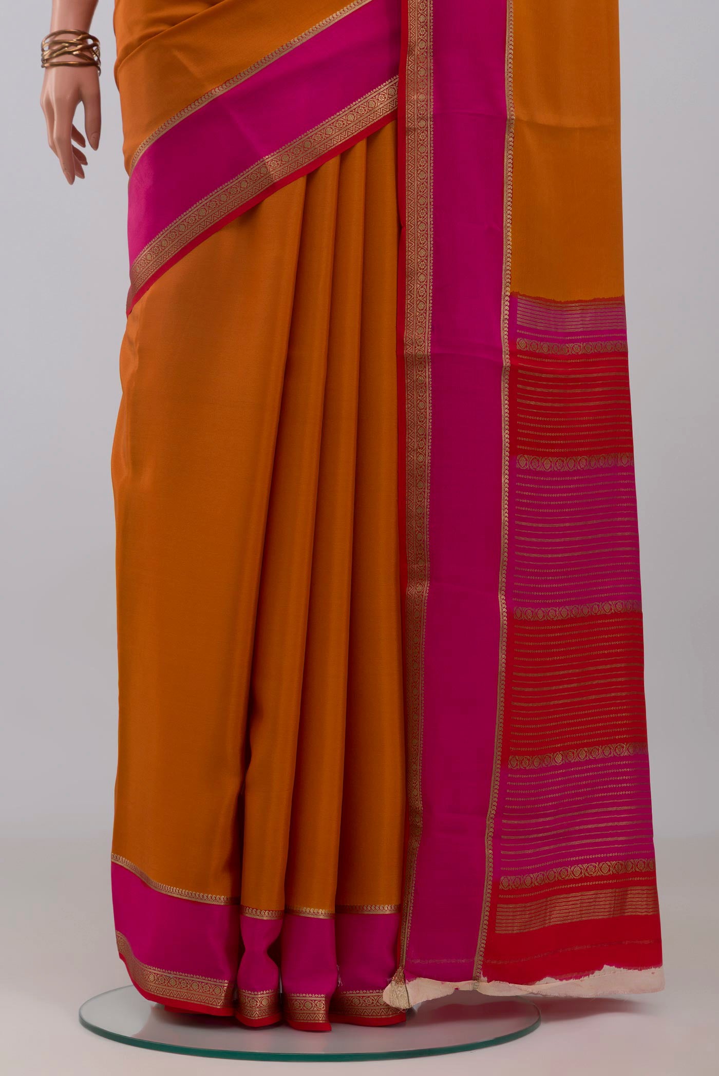 Pleats and pallu of Mustard Mysore Crepe Saree with Plain Body and Zari Border. 