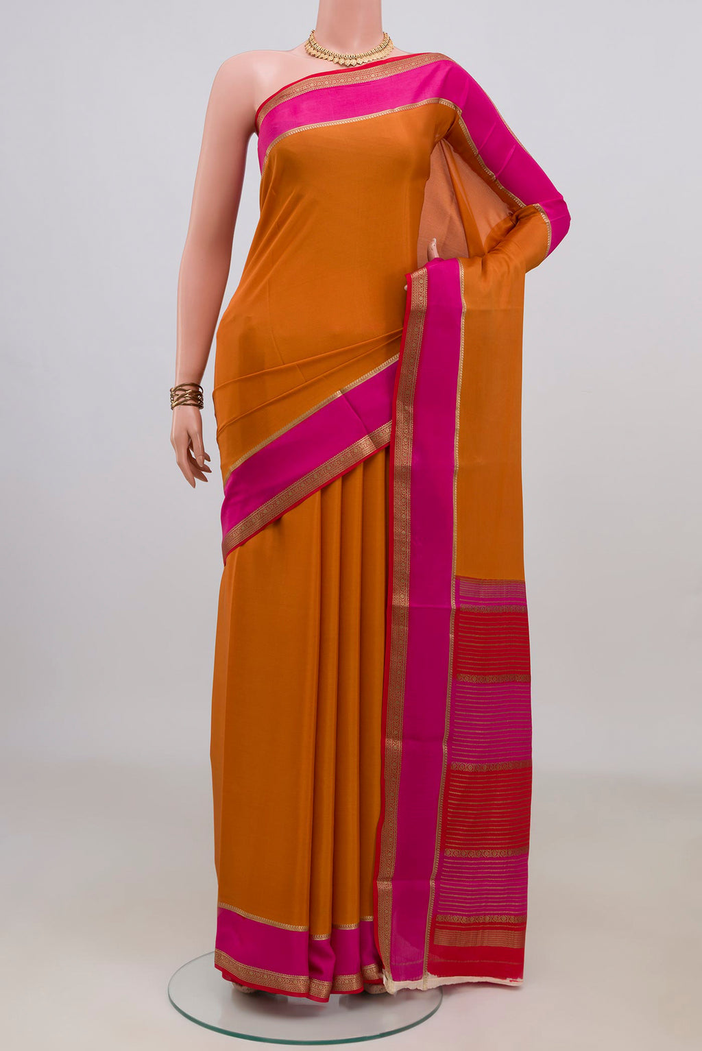 Orange Mysore Crepe Saree with Plain Body and Zari Border.  displayed on a mannequin