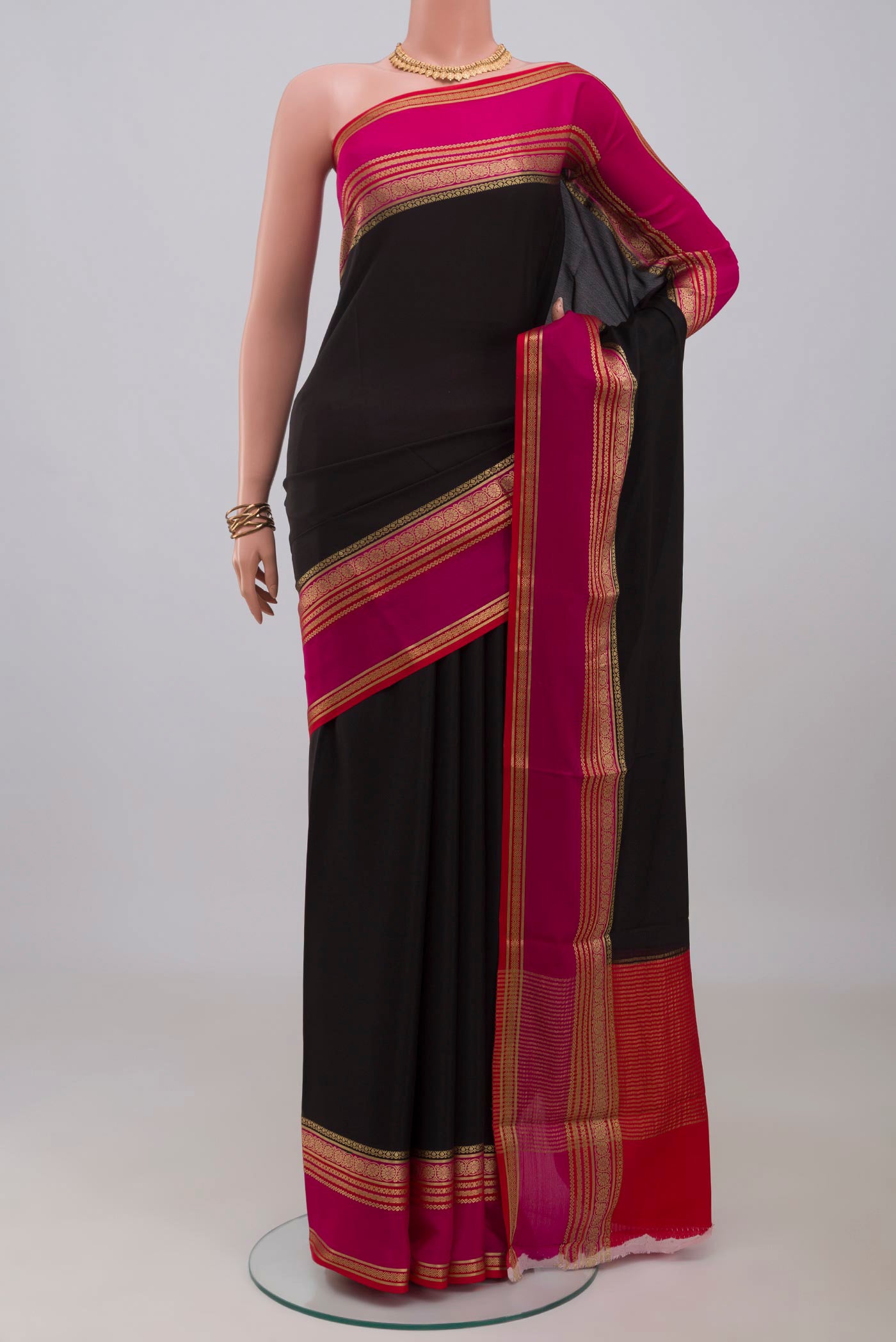 Black Mysore Crepe Saree with Plain Body and Zari Border.  displayed on a mannequin