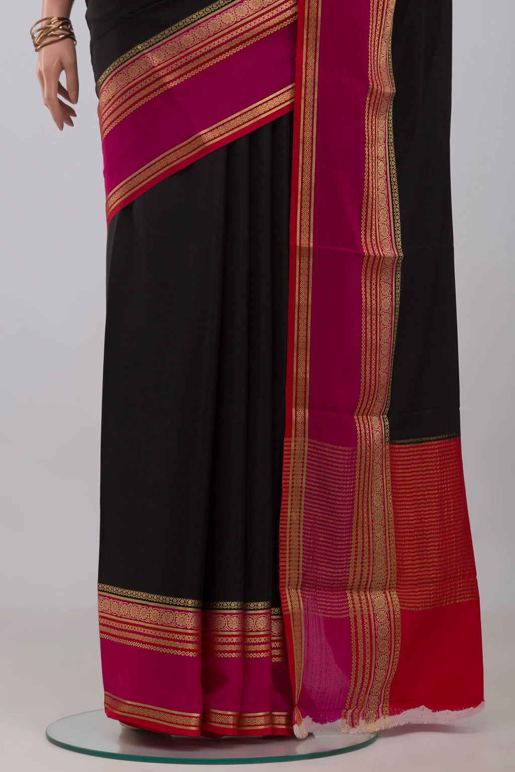 Pleats and pallu of Black Mysore Crepe Saree with Plain Body and Zari Border. 
