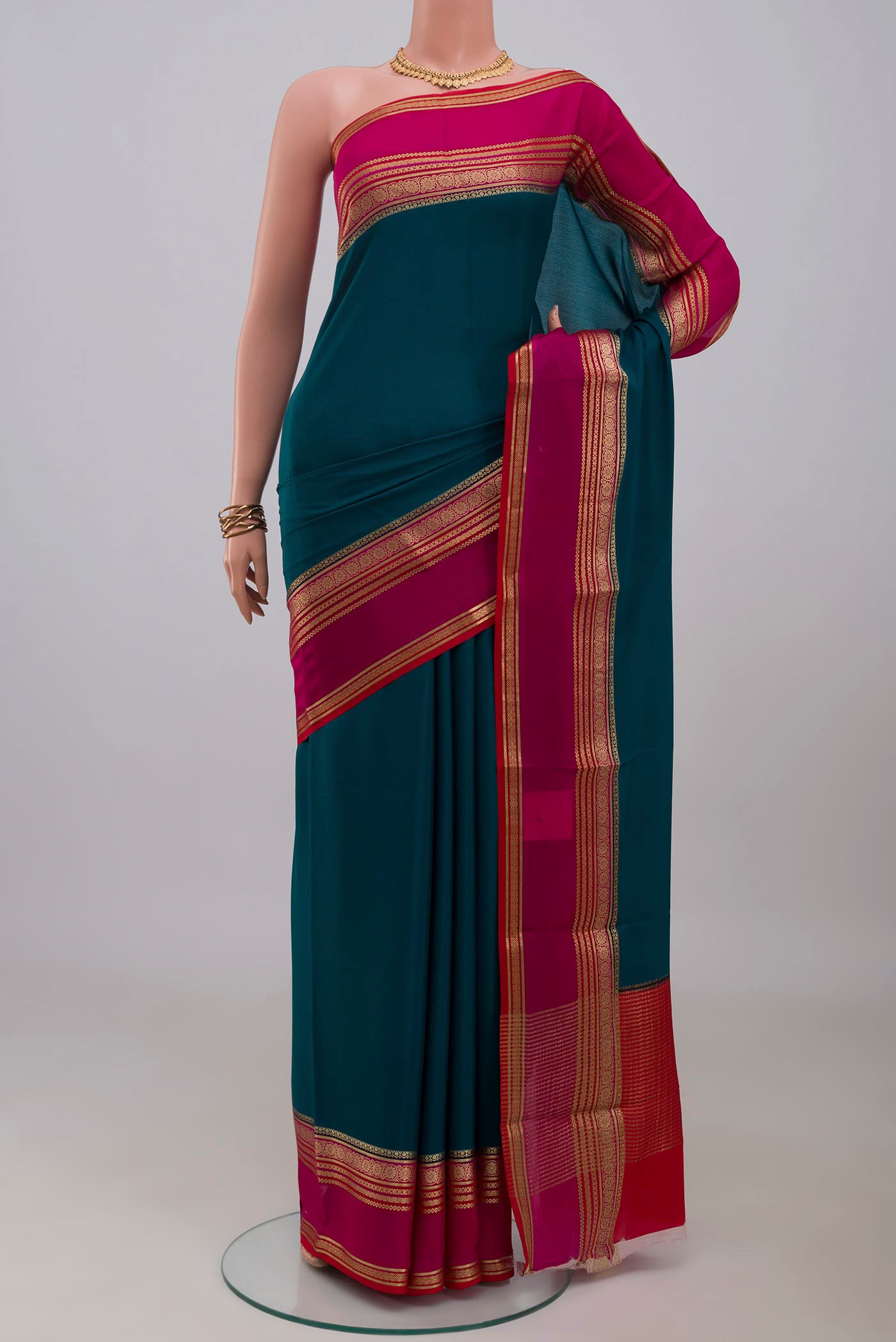 Blue Mysore Crepe Saree with Plain Body and Zari Border.  displayed on a mannequin