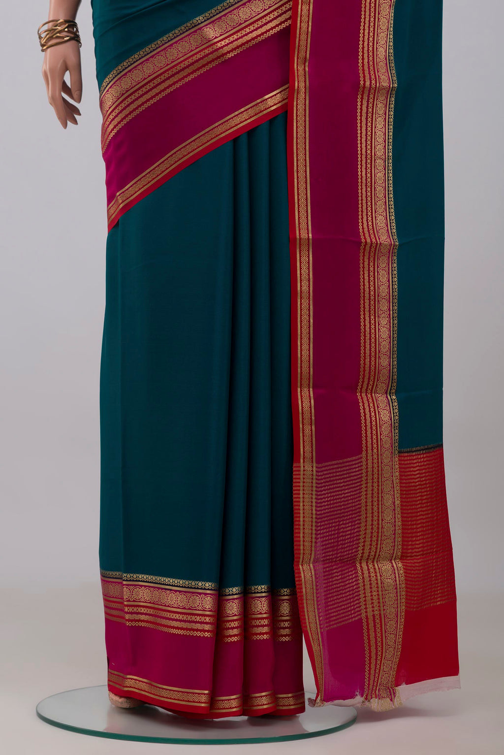 Pleats and pallu of Blue Mysore Crepe Saree with Plain Body and Zari Border. 