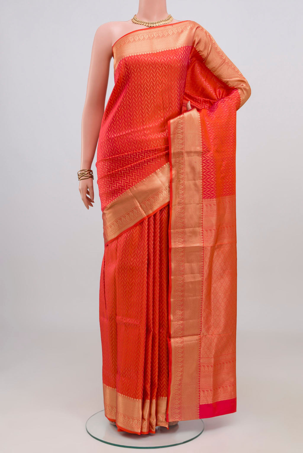 Orange Soft Silk Saree with Zari Brocade on the body and Zari Border.  displayed on a mannequin