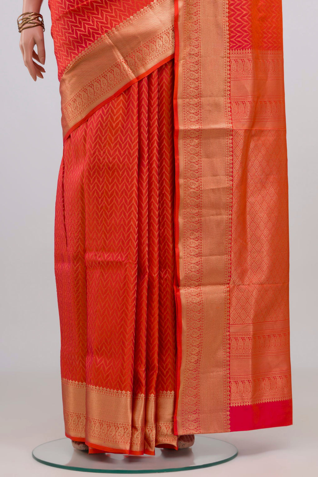 Pleats and pallu of Orange Soft Silk Saree with Zari Brocade on the body and Zari Border. 