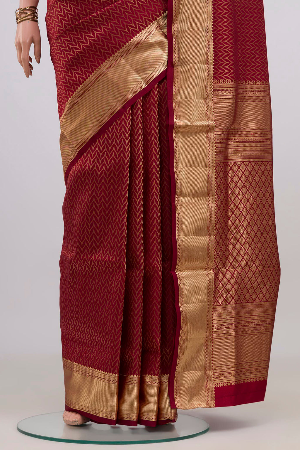 Pleats and pallu of Maroon Soft Silk Saree with Zari Brocade on the body and Zari Border. 