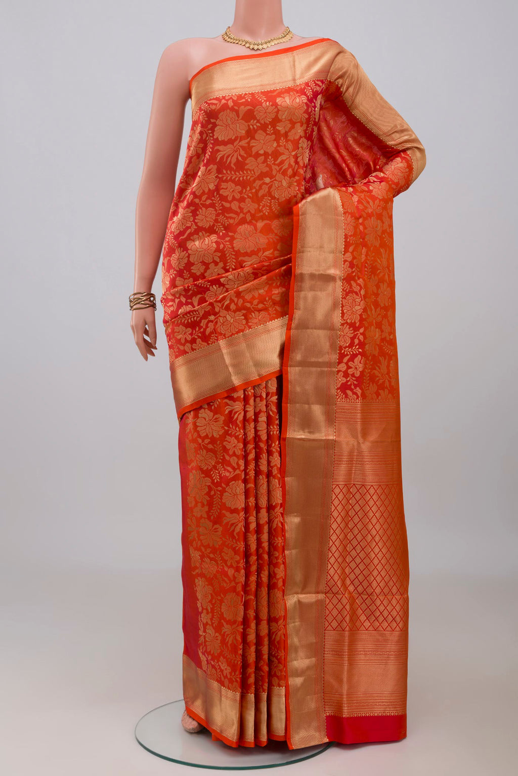 Orange Soft Silk Saree with Zari Brocade on the body and Zari Border.  displayed on a mannequin