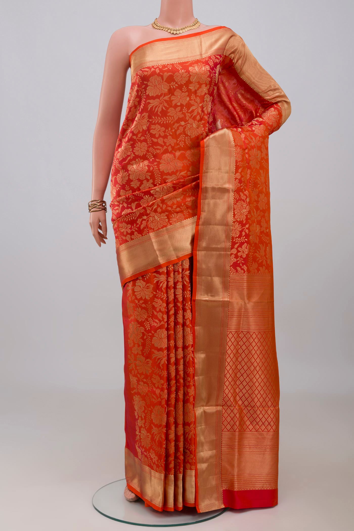 Orange Soft Silk Saree with Zari Brocade on the body and Zari Border.  displayed on a mannequin