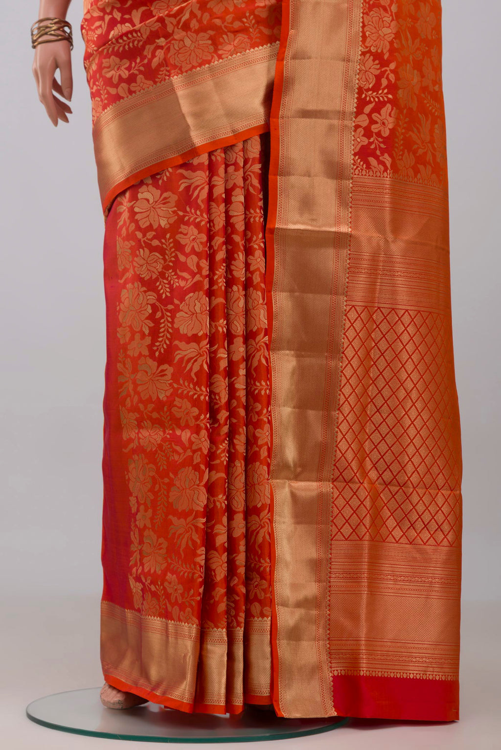 Pleats and pallu of Orange Soft Silk Saree with Zari Brocade on the body and Zari Border. 